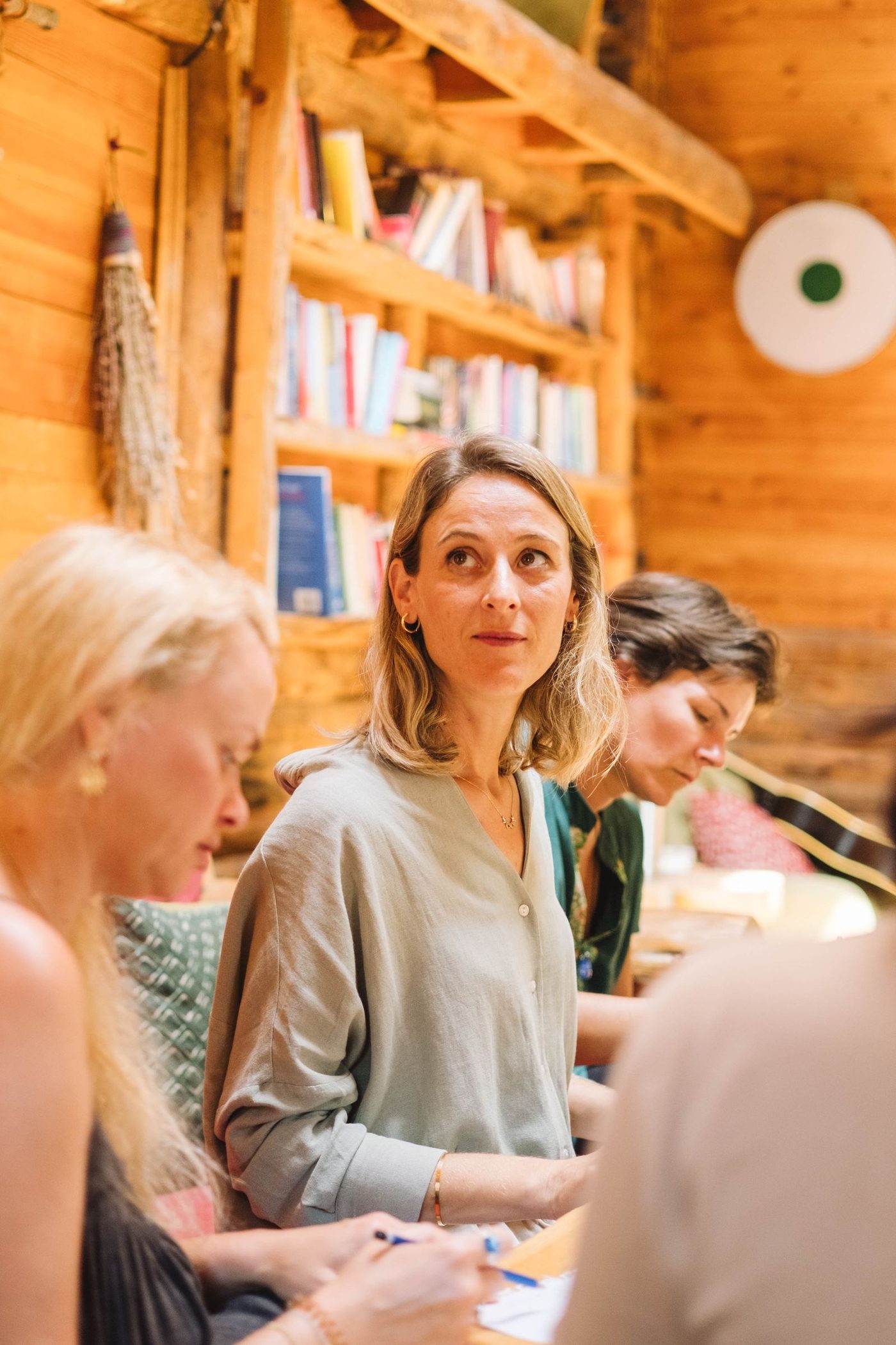 Adults learning together in a warm wood cabin